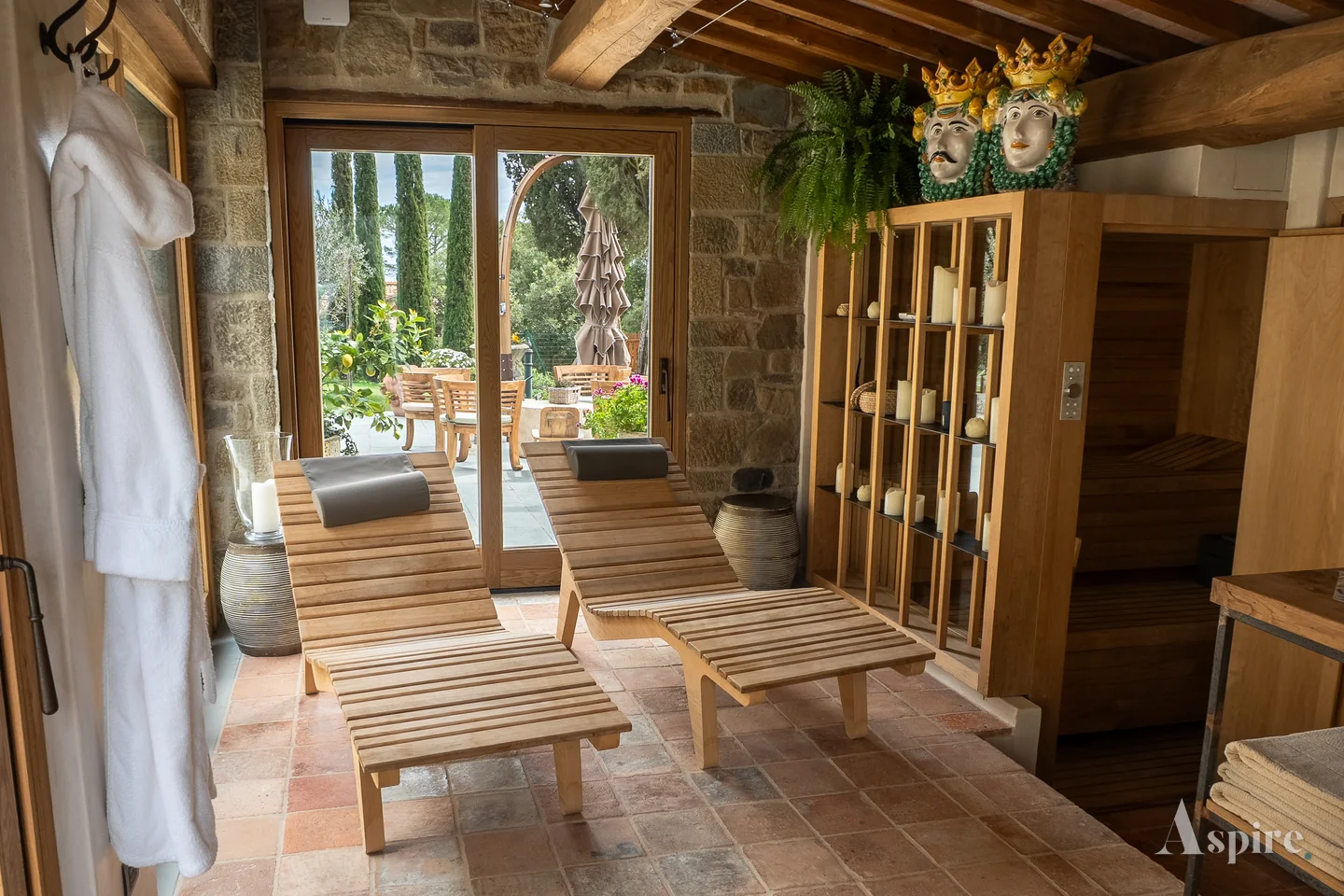 A shaded timber terrace with loungers opening onto the garden