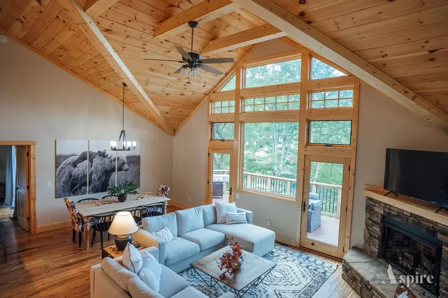 Open kitchen with a stone island under a vaulted timber ceiling