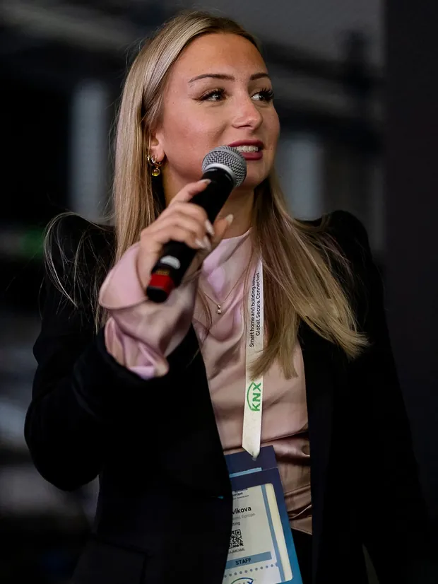 Speaking into a microphone at an event