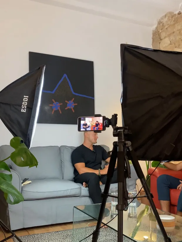 Studio lighting and a camera tripod set up for an interview