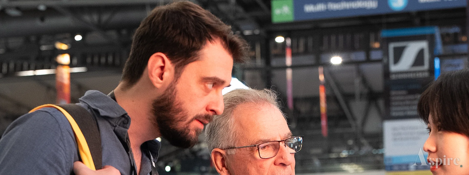 Two people in conversation beside an exhibition stand
