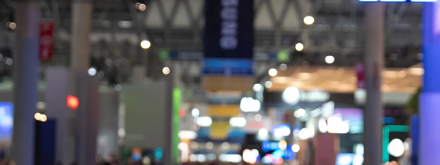 Crowded exhibition floor at Integrated Systems Europe under the gantry signage