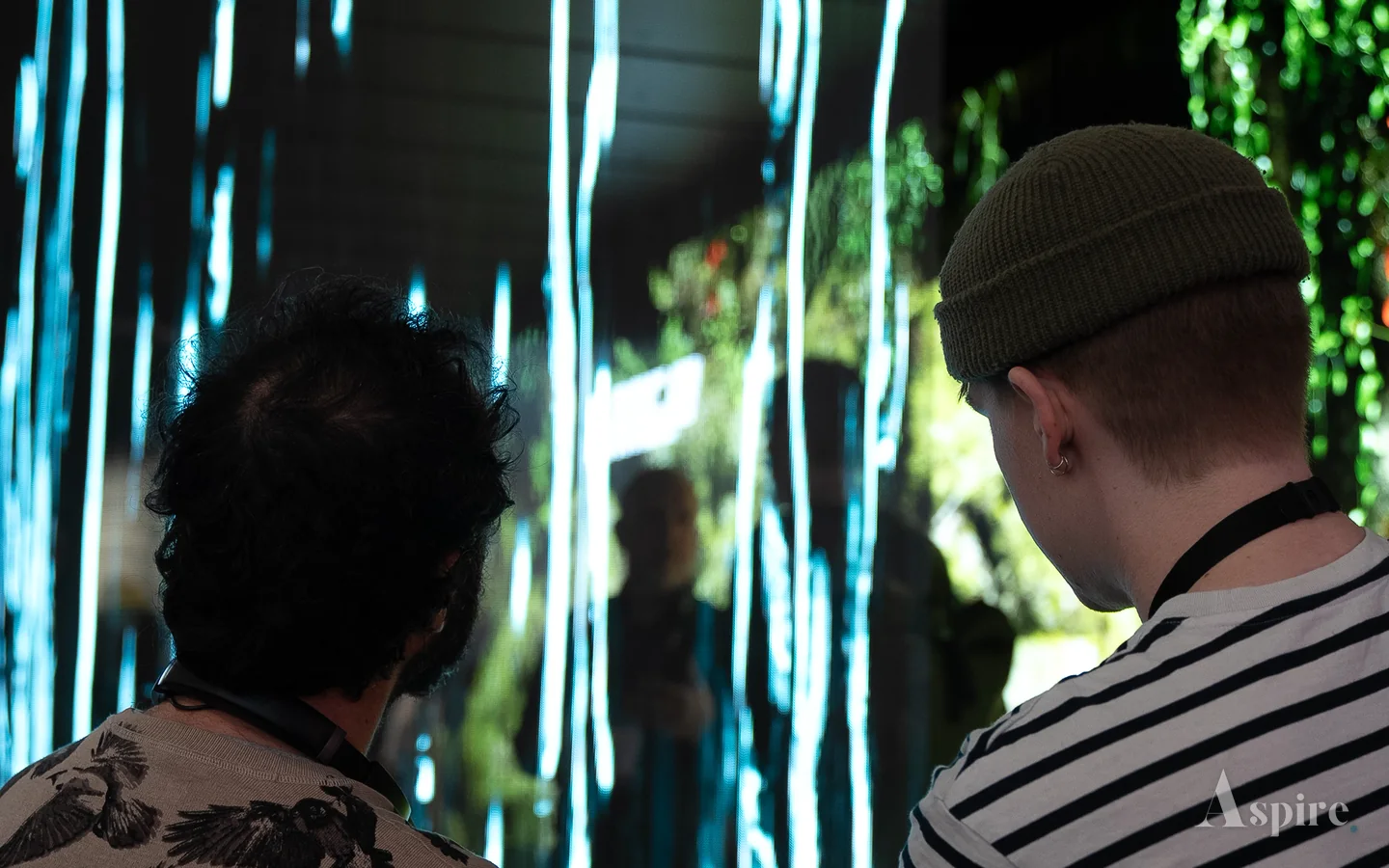 Two visitors in front of a full height LED installation on the show floor